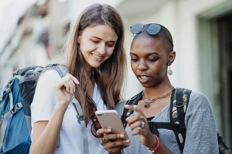 two women are looking at a phone