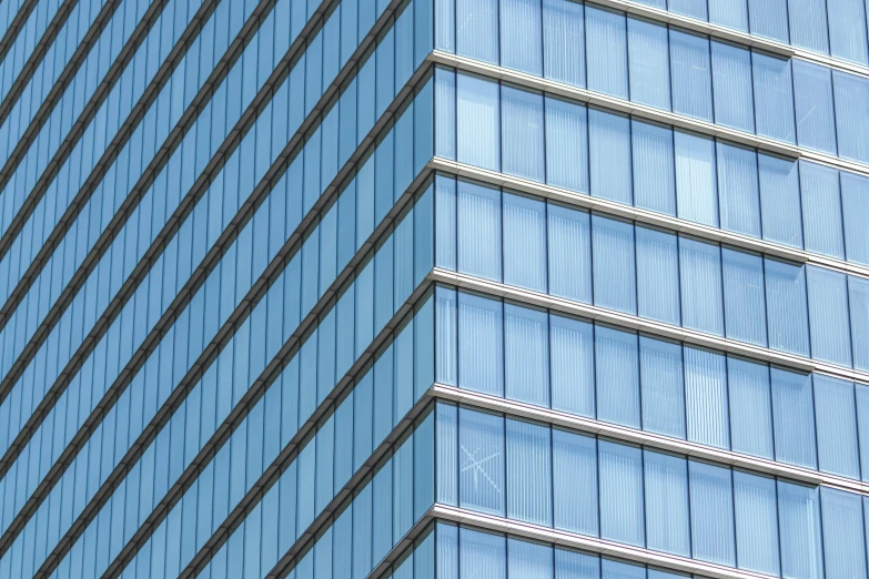 a red traffic light sitting on the side of a tall building