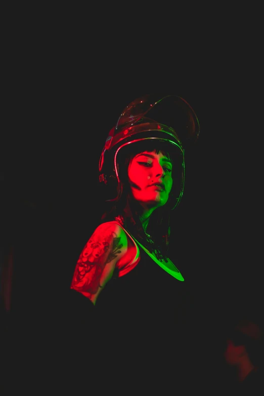 the woman is wearing a hat with a green light on her face