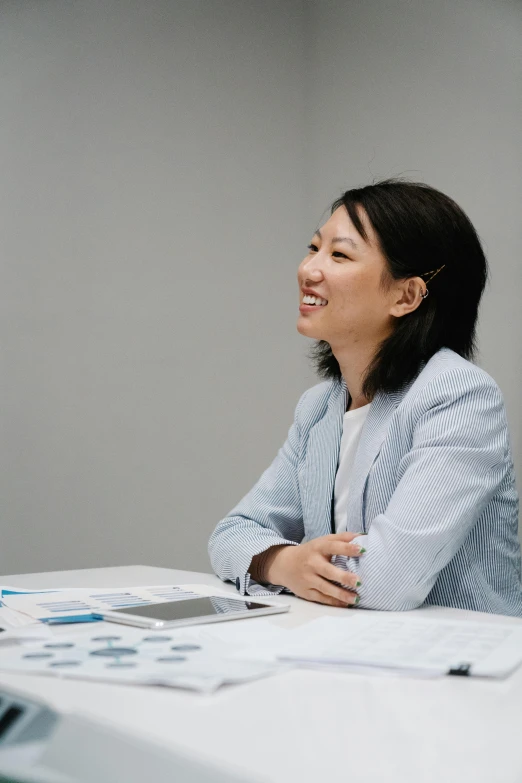 a woman smiling and sitting at a table