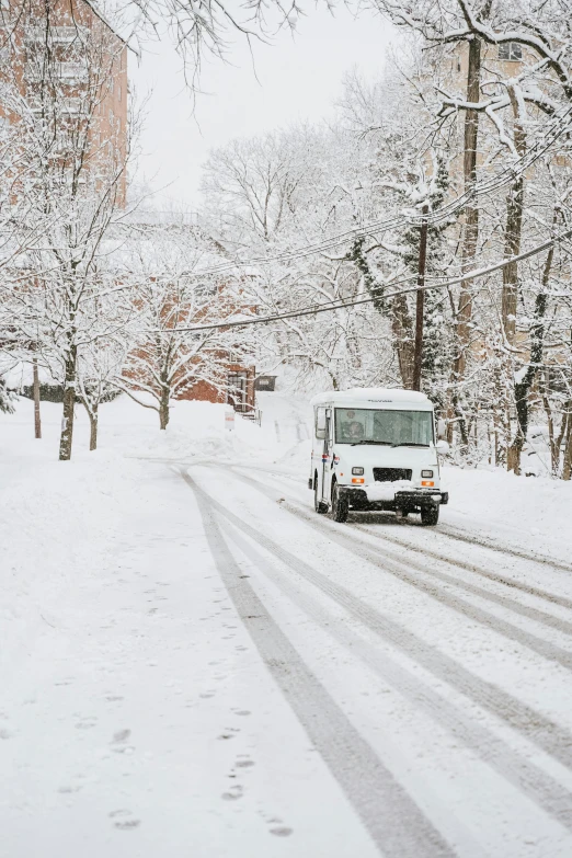 a truck is driving down a snowy road