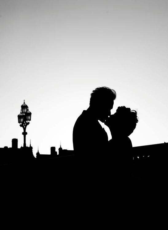 a man and woman silhouetted in the silhouette of a building