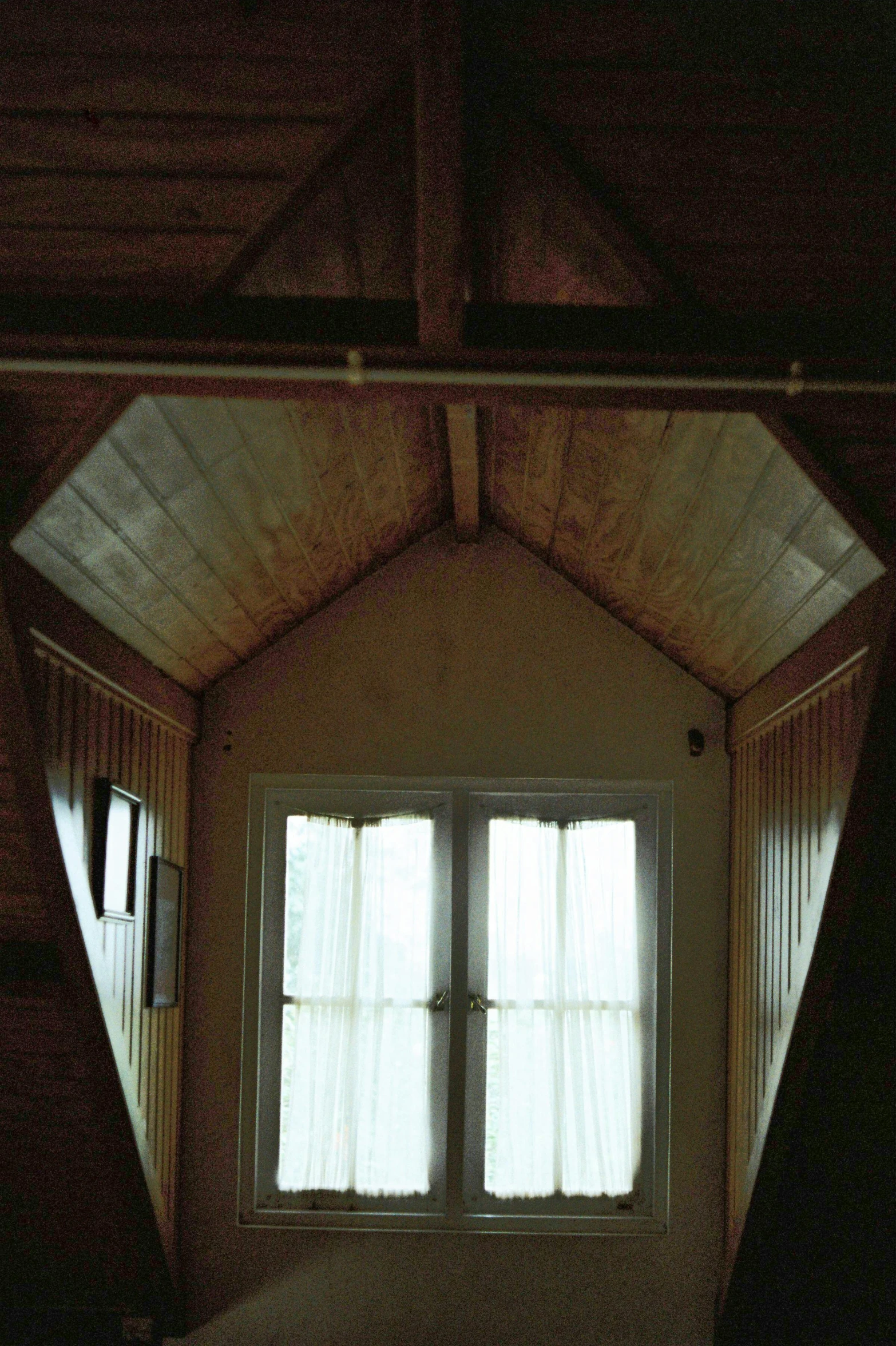 an open doorway in an old house with a white curtain and the light shining in the window