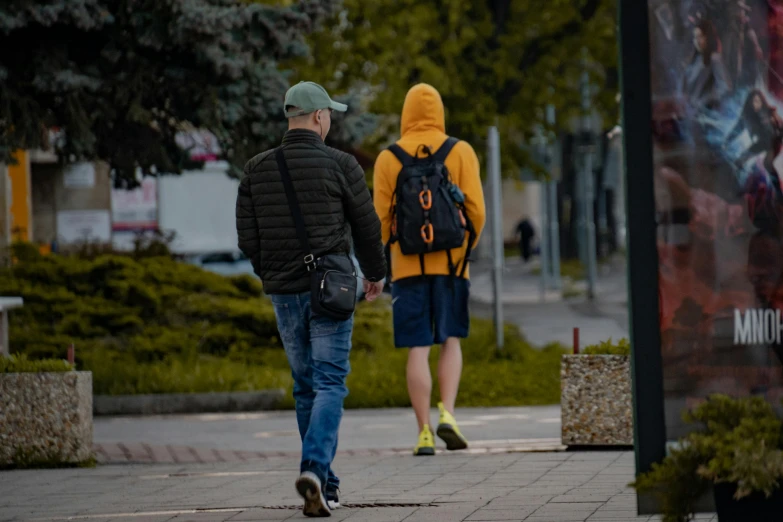 a couple of men wearing yellow and black jackets