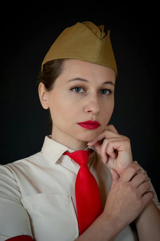 a person with a red tie and a yellow cap