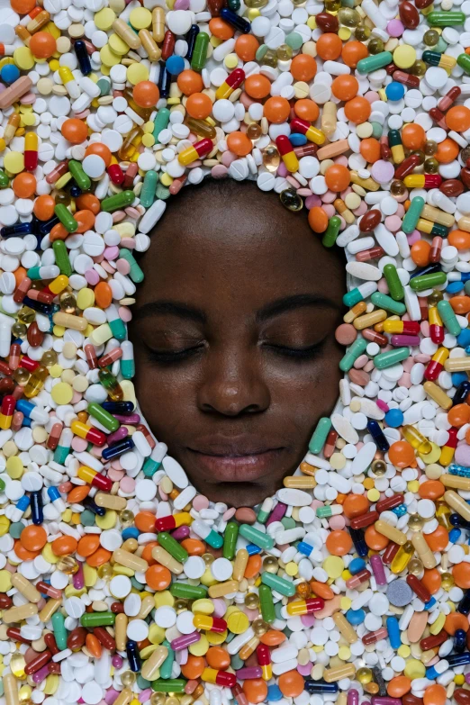 a woman in a sprinkled hat with pills all over her