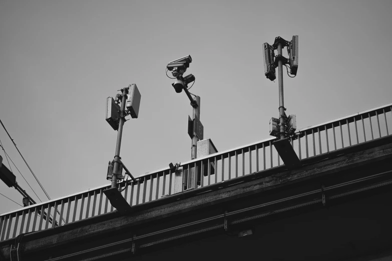 black and white pograph of different lamps and a bridge