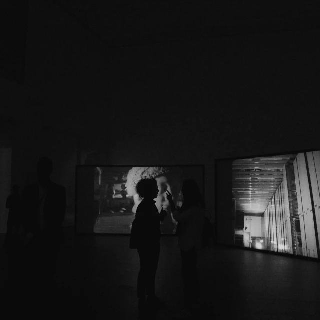 people looking at some art on a wall