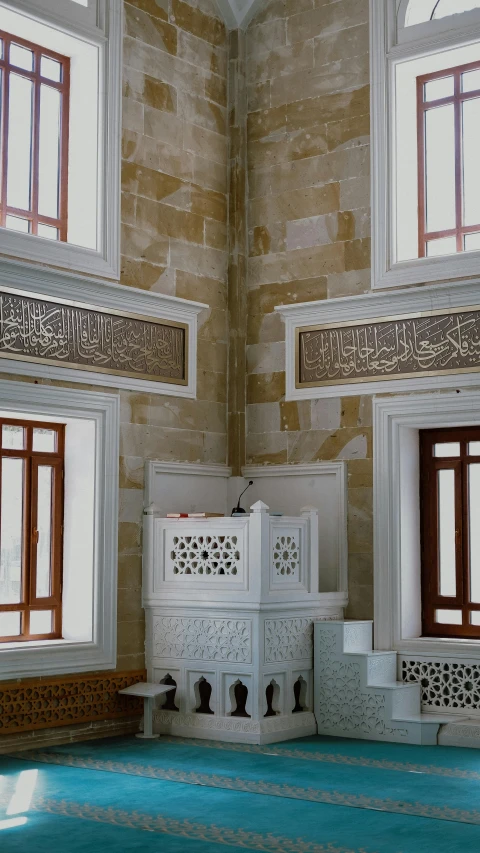 an ornate white box sitting under a window in a building