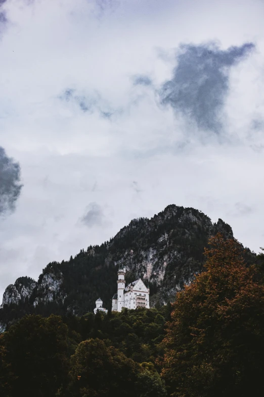 a castle sitting on top of a mountain in the background