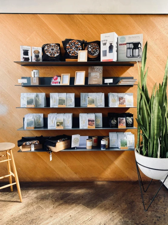 a shelf holding different kinds of books next to a chair