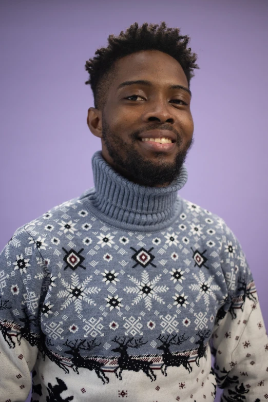 a man with a beard in a blue sweater