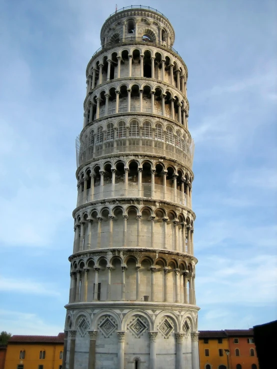 a tall white building with a sky background