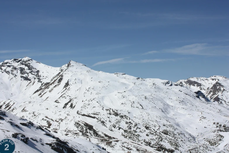 a person snowboarding down a mountain in the mountains