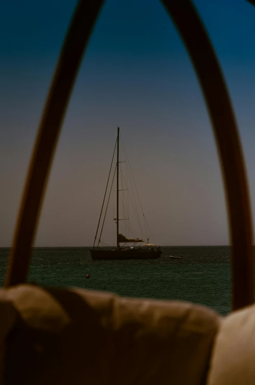 a sail boat in the ocean with it's mast extended