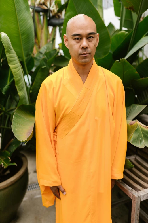 a man in a robe poses for the camera