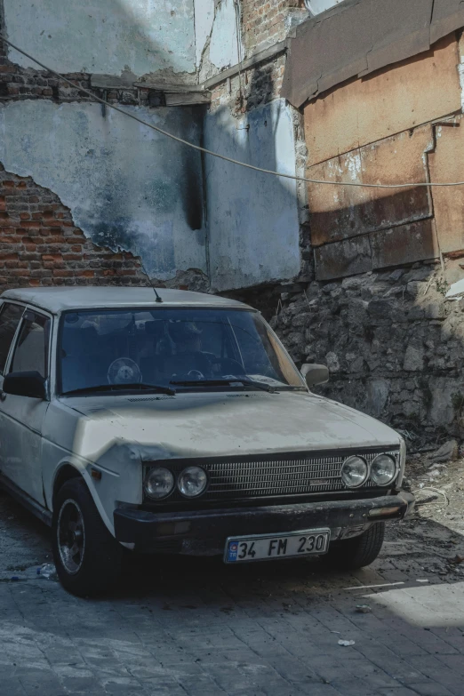 the old car is parked by the ed up building