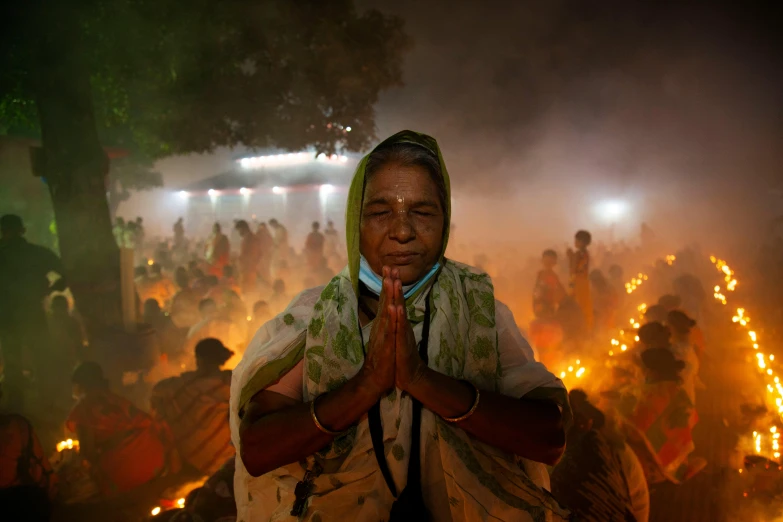 people in india doing meditation at night with lit candles