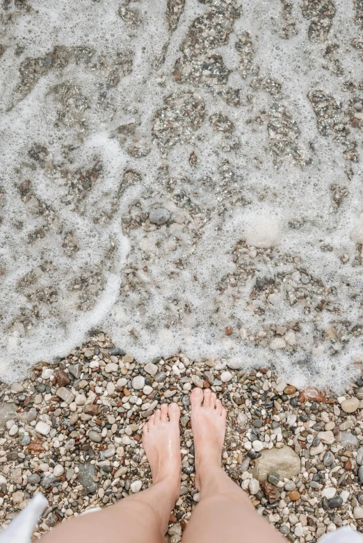 the view of someone standing in the sand at the beach