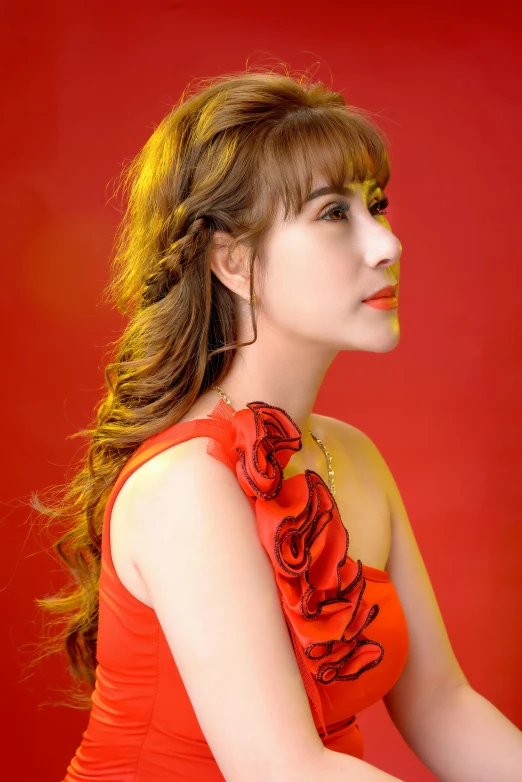 the woman is wearing red clothing and is posing