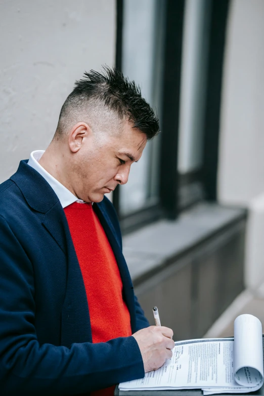 a man with a pen and notebook on a table