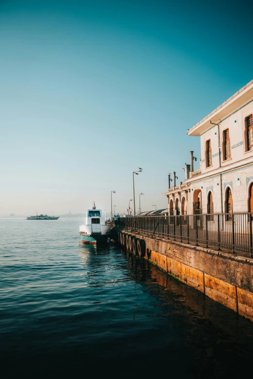 a boat moored to a building by a dock