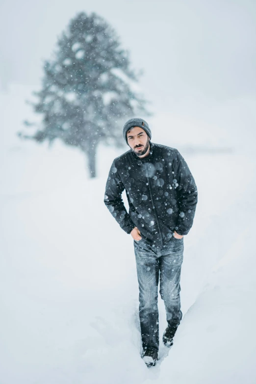 man walking through snow while smiling in the snow