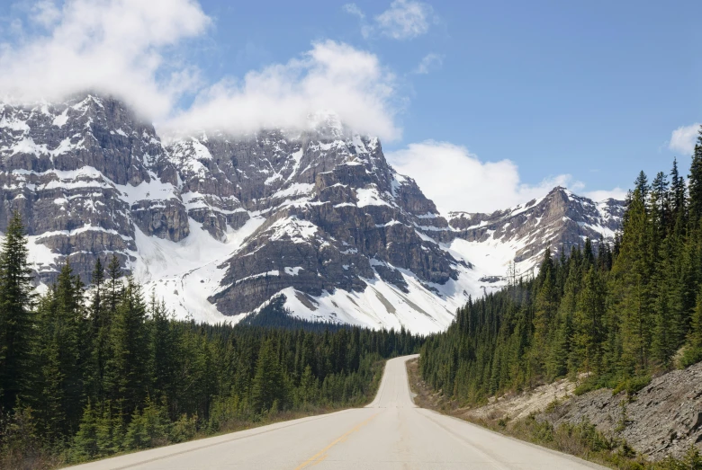 the long and winding road leads to a snowy mountain