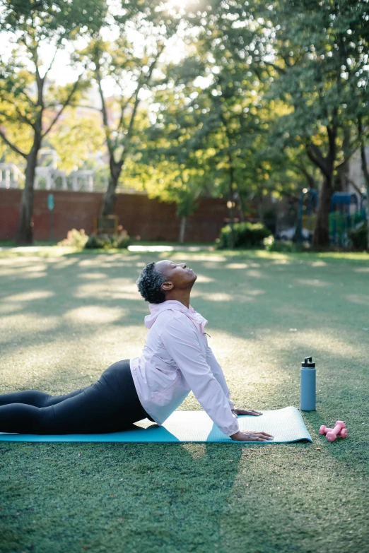 an older woman stretches out in the park