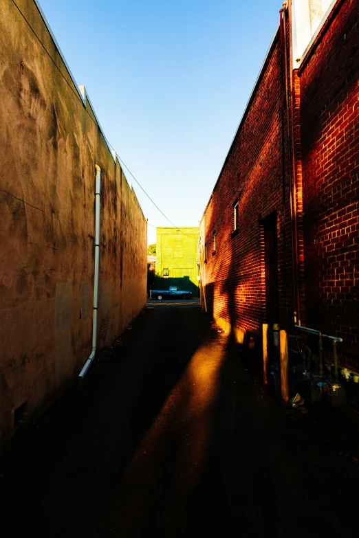 a long and skinny road that has buildings on both sides