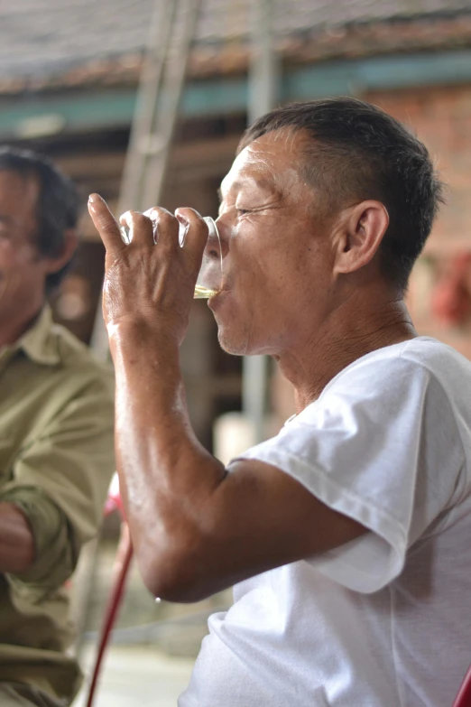 a man holding a small glass with soing in it