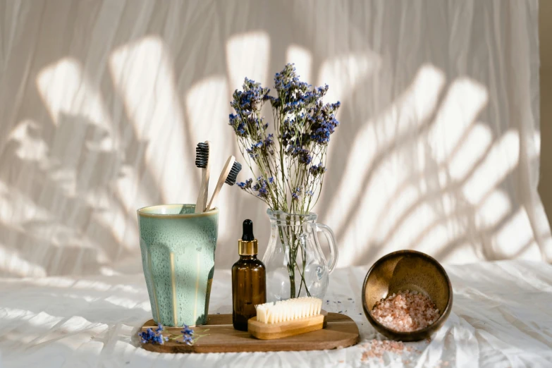 a vase, soap, and brush sitting on a table