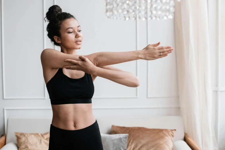 an asian woman stretching her arms in the air