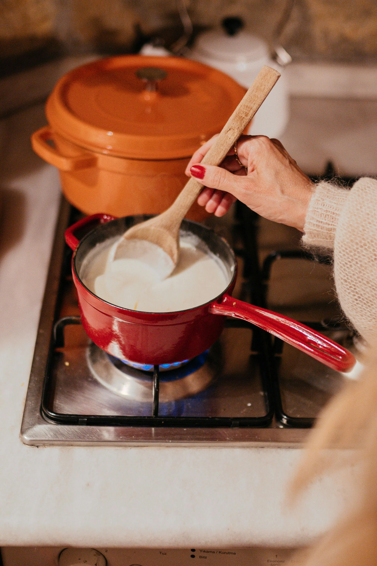 a person is stirring some liquid on a kitchen stove