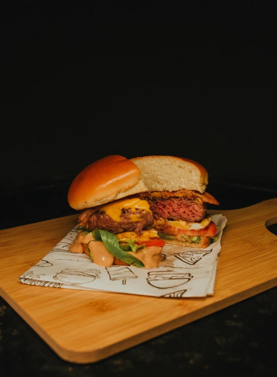 a cheeseburger is on top of a  board