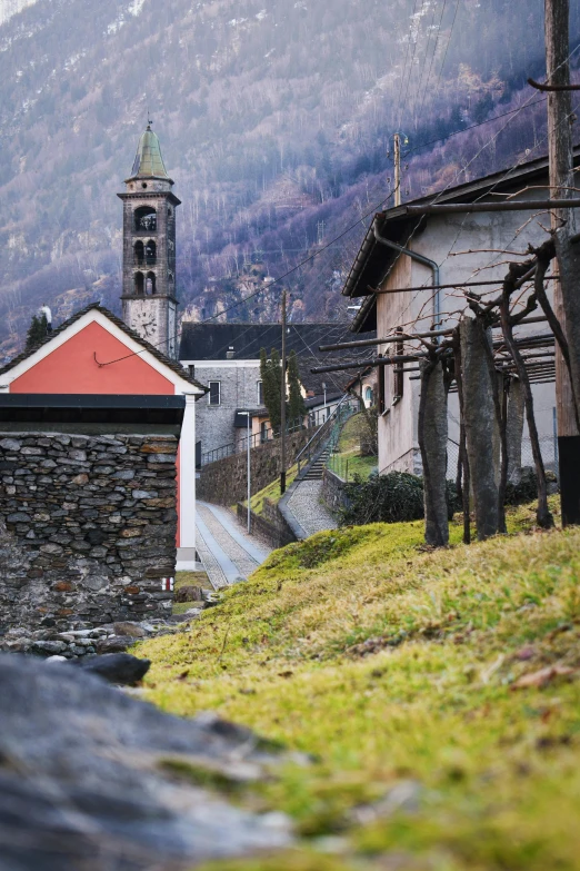 an old church next to some steeples in the mountains