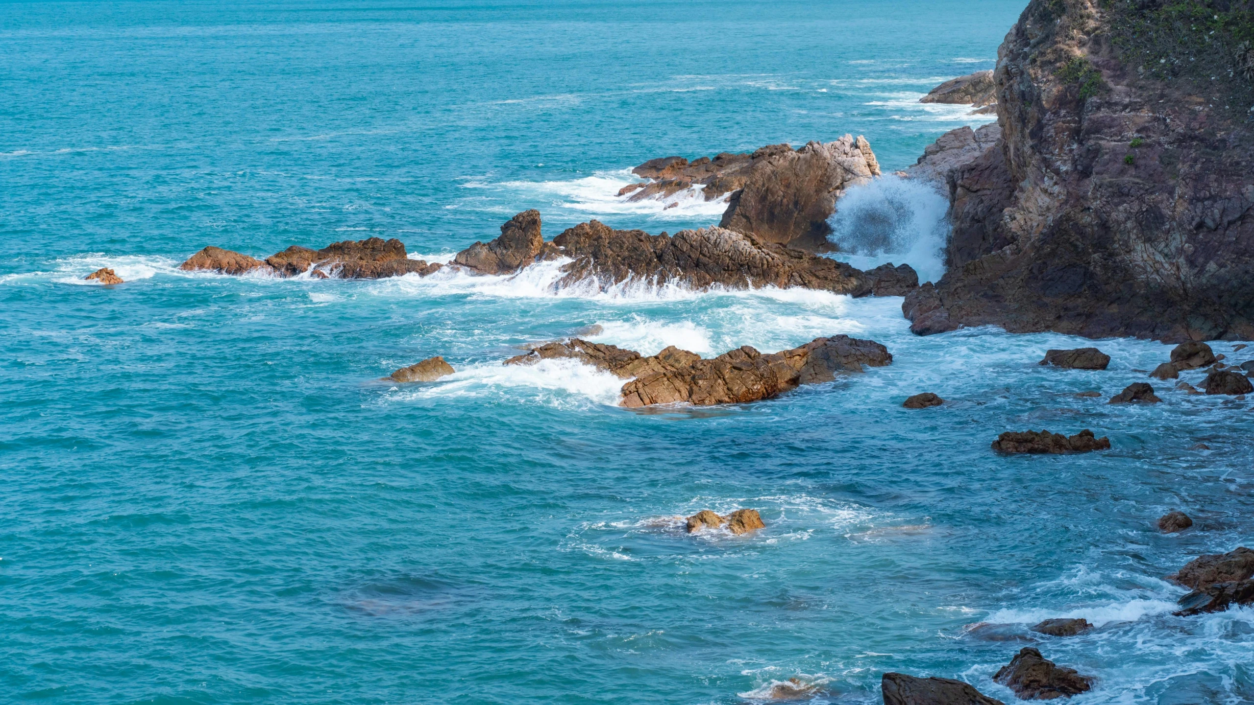 waves crashing into the rocks off of the coast