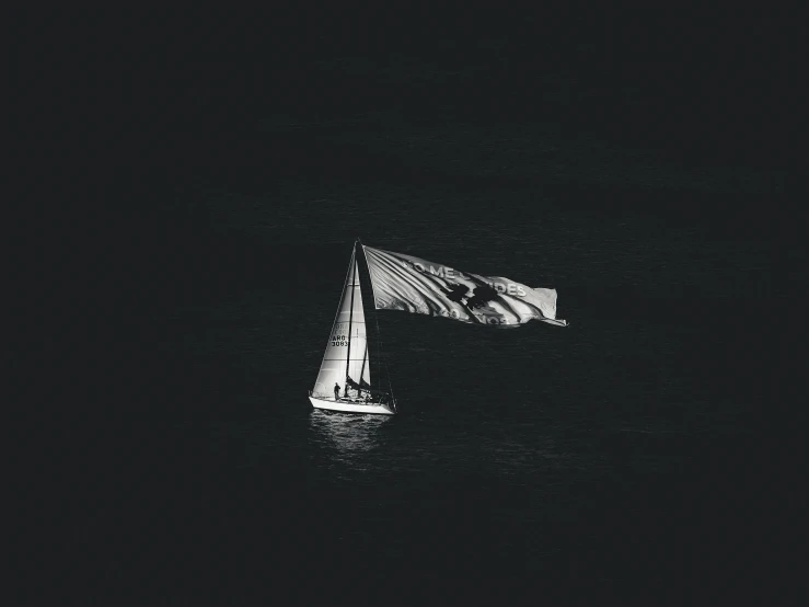 a picture of the sailboat in the dark water