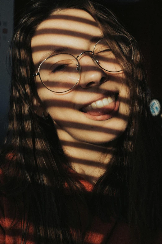 a woman wearing glasses with stripes coming out of her face