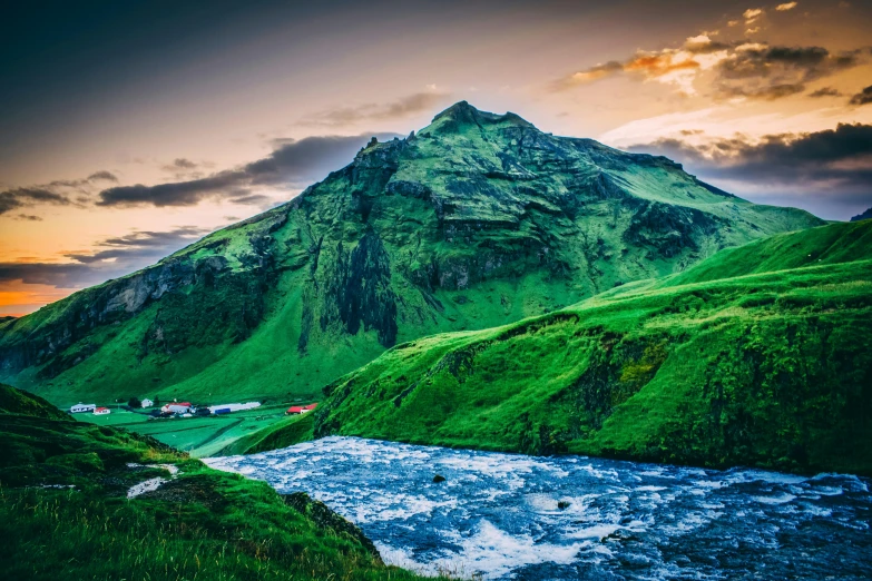 green mountains with a river in between them