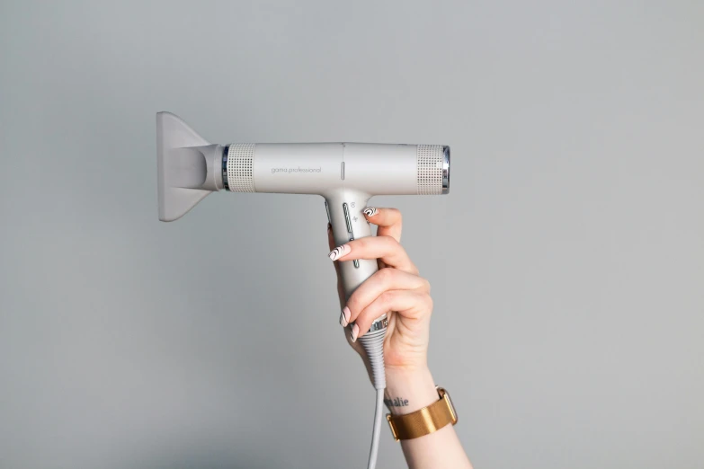 a woman holding a hair dryer in her hand