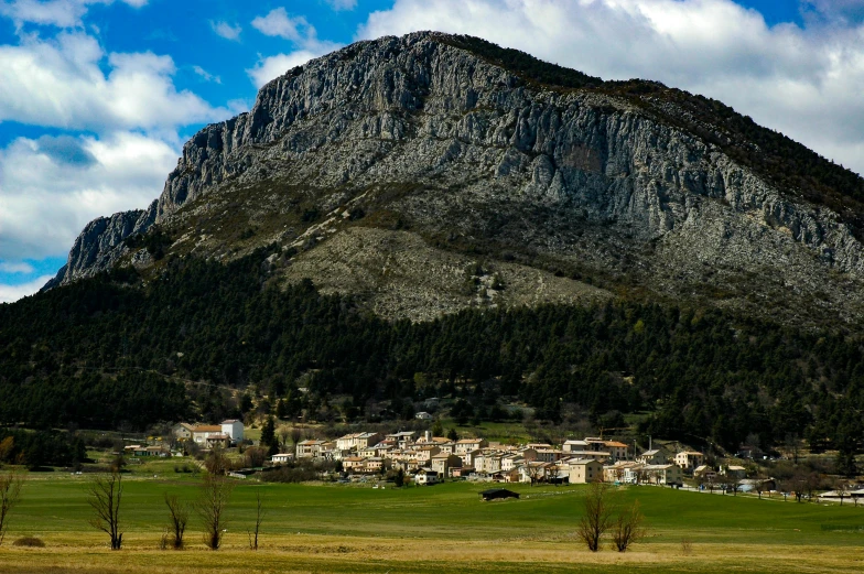 the view of a village and mountains in a valley