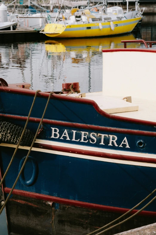 several different boats are in a small harbor