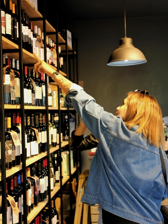 a woman looking for some wine in the bar