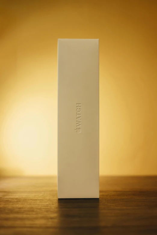 a white box is standing on a wood table