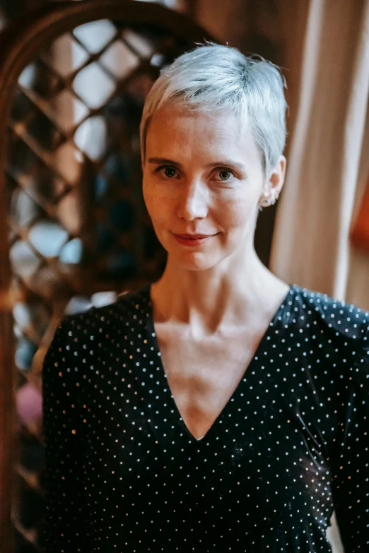 a woman in a polka dot top posing for the camera