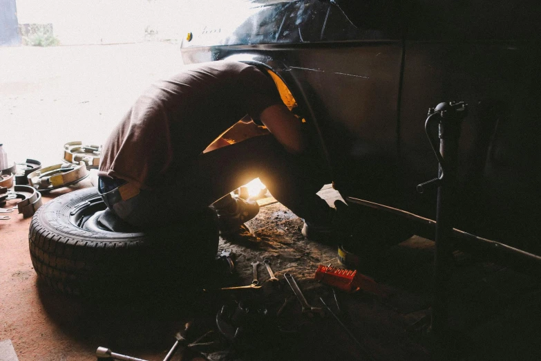 a person welding a tire in a garage