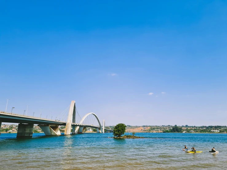 a river with people riding on water boards