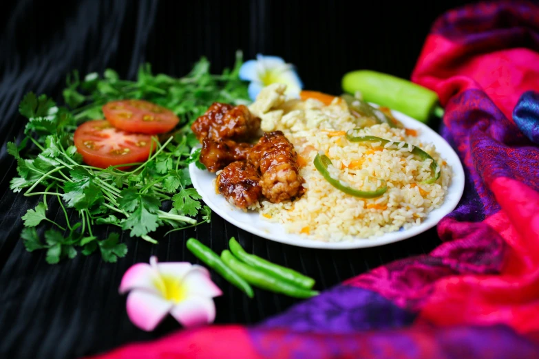 a plate of food sitting on top of a black cloth