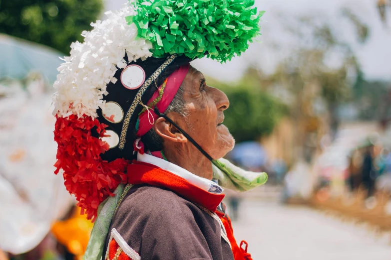 an old man wearing a floral headdress and bright colors